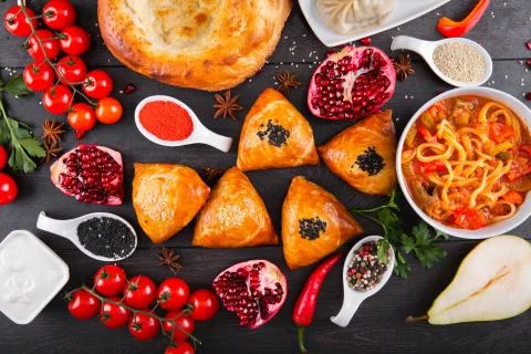 The concept of Eastern festive cuisine. Assorted Uzbek food set, pilaf, samsa Stock Photos