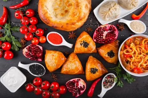 The concept of Eastern festive cuisine. Assorted Uzbek food set, pilaf, samsa Stock Photos
