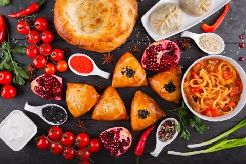 The concept of Eastern festive cuisine. Assorted Uzbek food set, pilaf, samsa Stock Photos