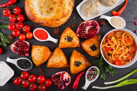 The concept of Eastern festive cuisine. Assorted Uzbek food set, pilaf, samsa Stock Photos