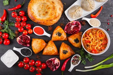 The concept of Eastern festive cuisine. Assorted Uzbek food set, pilaf, samsa Stock Photos