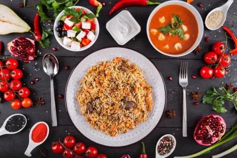 The concept of Eastern festive cuisine. Assorted Uzbek food set, pilaf, samsa Stock Photos