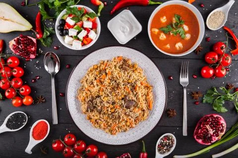 The concept of Eastern festive cuisine. Assorted Uzbek food set, pilaf, samsa Stock Photos