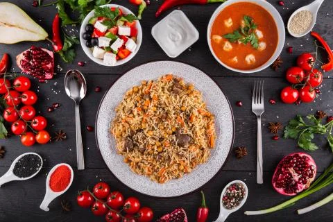 The concept of Eastern festive cuisine. Assorted Uzbek food set, pilaf, samsa Stock Photos