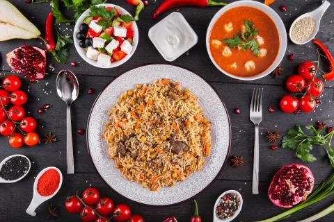 The concept of Eastern festive cuisine. Assorted Uzbek food set, pilaf, samsa Stock Photos