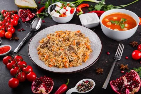 The concept of Eastern festive cuisine. Assorted Uzbek food set, pilaf, samsa Stock Photos