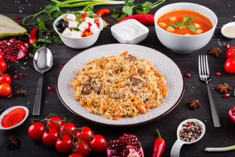 The concept of Eastern festive cuisine. Assorted Uzbek food set, pilaf, samsa Stock Photos