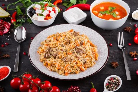 The concept of Eastern festive cuisine. Assorted Uzbek food set, pilaf, samsa Stock Photos