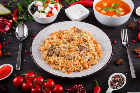 The concept of Eastern festive cuisine. Assorted Uzbek food set, pilaf, samsa Stock Photos