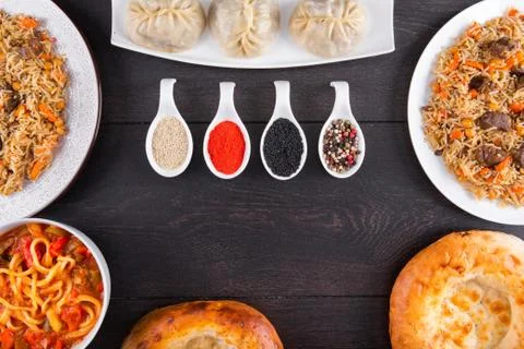 The concept of Eastern festive cuisine. Assorted Uzbek food set, pilaf, samsa Stock Photos