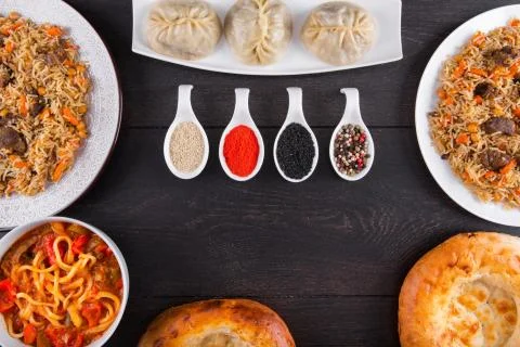 The concept of Eastern festive cuisine. Assorted Uzbek food set, pilaf, samsa Stock Photos