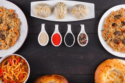 The concept of Eastern festive cuisine. Assorted Uzbek food set, pilaf, samsa Stock Photos