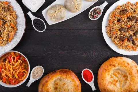 The concept of Eastern festive cuisine. Assorted Uzbek food set, pilaf, samsa Stock Photos