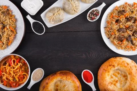 The concept of Eastern festive cuisine. Assorted Uzbek food set, pilaf, samsa Stock Photos