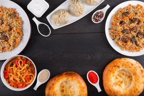 The concept of Eastern festive cuisine. Assorted Uzbek food set, pilaf, samsa Stock Photos