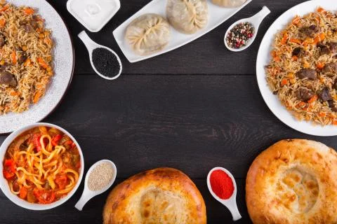 The concept of Eastern festive cuisine. Assorted Uzbek food set, pilaf, samsa Stock Photos