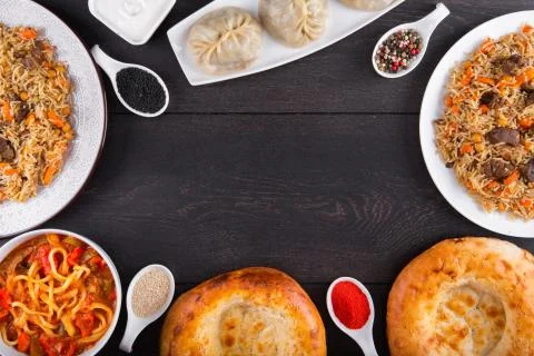 The concept of Eastern festive cuisine. Assorted Uzbek food set, pilaf, samsa Stock Photos