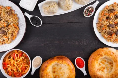 The concept of Eastern festive cuisine. Assorted Uzbek food set, pilaf, samsa Stock Photos