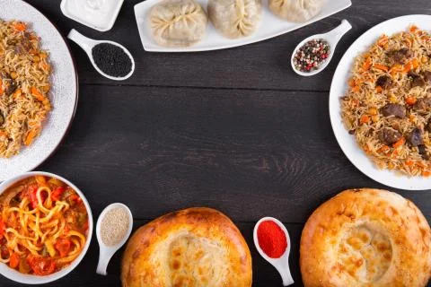 The concept of Eastern festive cuisine. Assorted Uzbek food set, pilaf, samsa Stock Photos