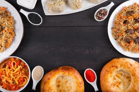 The concept of Eastern festive cuisine. Assorted Uzbek food set, pilaf, samsa Stock Photos