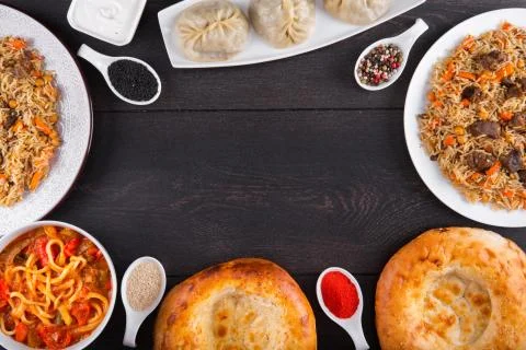 The concept of Eastern festive cuisine. Assorted Uzbek food set, pilaf, samsa Stock Photos