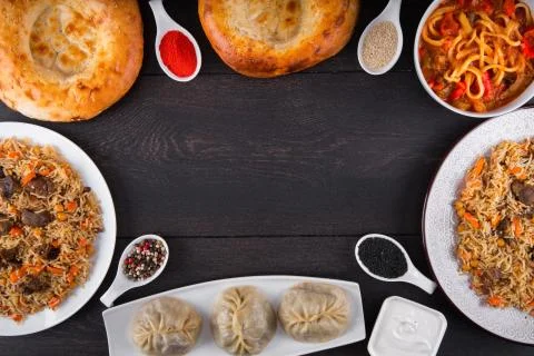 The concept of Eastern festive cuisine. Assorted Uzbek food set, pilaf, samsa Stock Photos