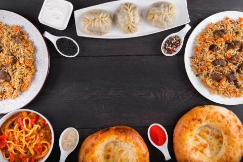 The concept of Eastern festive cuisine. Assorted Uzbek food set, pilaf, samsa Stock Photos