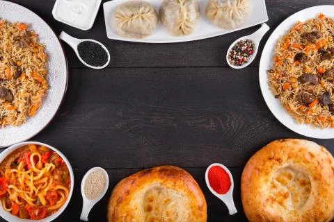 The concept of Eastern festive cuisine. Assorted Uzbek food set, pilaf, samsa Stock Photos