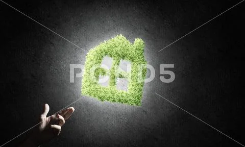 Concept of eco architecture presented by green house on dark bac Stock Photos