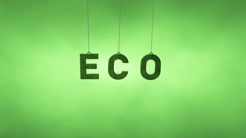 Concept ECO letters swing on the strings on blurred green background 库存影片 344142637