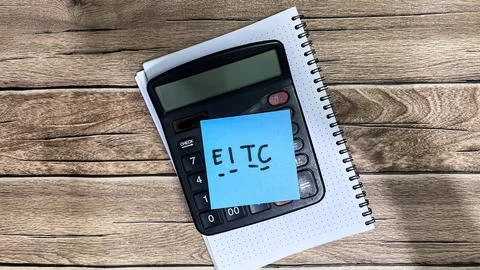Concept of EITC write on sticky notes isolated on Wooden Table. Stock Photos