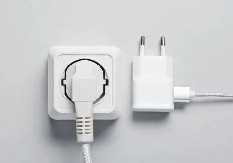 The concept of electrical dependence. The plug is plugged into the power outl Stockfoto's