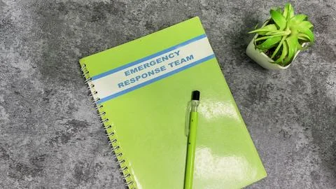 Concept of Emergency Response team write on book isolated on Wooden Table. Stock Photos