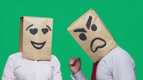 The concept of emotions and gestures. Two people in paper bags with a smile Stock Footage 96520279