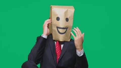 Concept of emotions, gestures. a man with paper bags on his head, with a painted Stock Footage 96511800