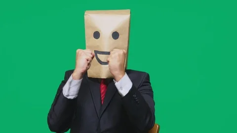 Concept of emotions, gestures. a man with paper bags on his head, with a painted Stock Footage 96709993