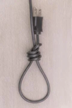 Concept of energy dependence: a blurred hinge loop made of an electric cord w Stock Photos