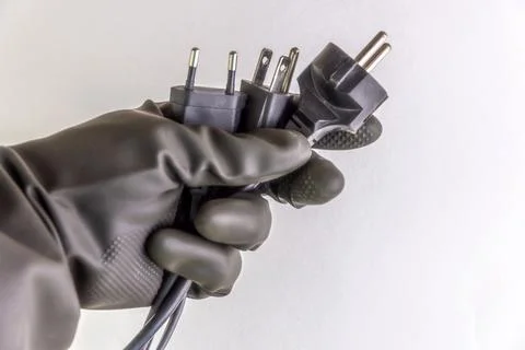 Concept of energy dependence: several different plugs and cables in the perso Stock Photos