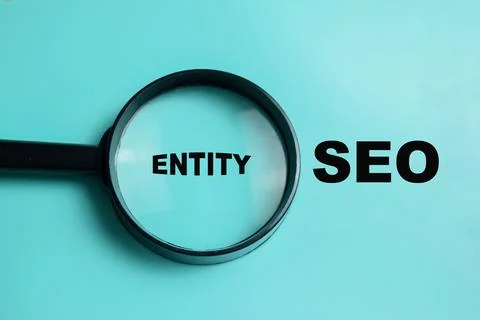 Concept of entity SEO write on book isolated on Wooden Table. Stock Photos
