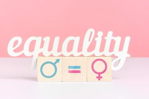 The concept of equal pay, the word equality stands on three wooden cubes with Stock Photos