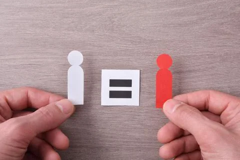 Concept equality between racial diversity with hands holding cutouts Stock Photos