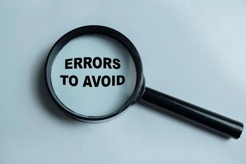 Concept of errors to avoid write on book isolated on Wooden Table. Stock Photos