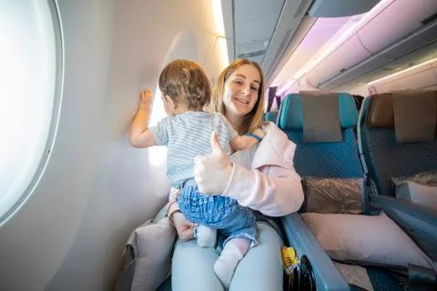 Concept everything is OK. lofe is good. mom shows thumb up and looks at the Stock Photos