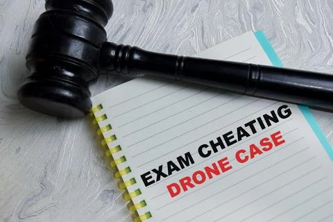 Concept of exam cheating drone case write on book isolated on Wooden Table. Stock Photos