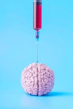 Concept experiments on human brain syringe with red drop of blood Stock Photos