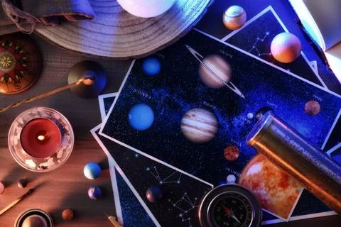 Concept of exploring planets and constellations with table with objects Stock Photos