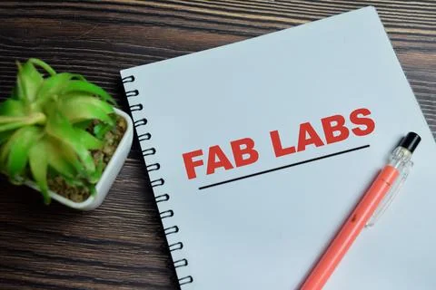 Concept of fab labs write on book isolated on Wooden Table. Foto stock