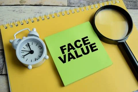 Concept of face values write on sticky notes isolated on Wooden Table. Stock Photos