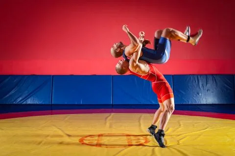 The concept of fair wrestling. Two greco-roman  wrestlers in red and blue uni Stock Photos