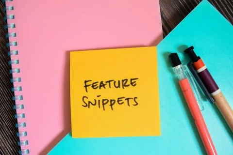 Concept of Feature Snippets write on sticky notes isolated on Wooden Table. Stock Photos